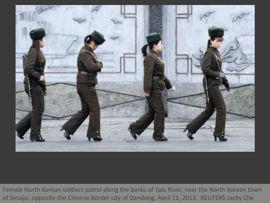 female north korean soldiers patrol along