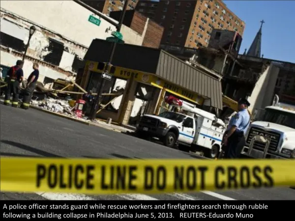 a police officer stands guard while rescue