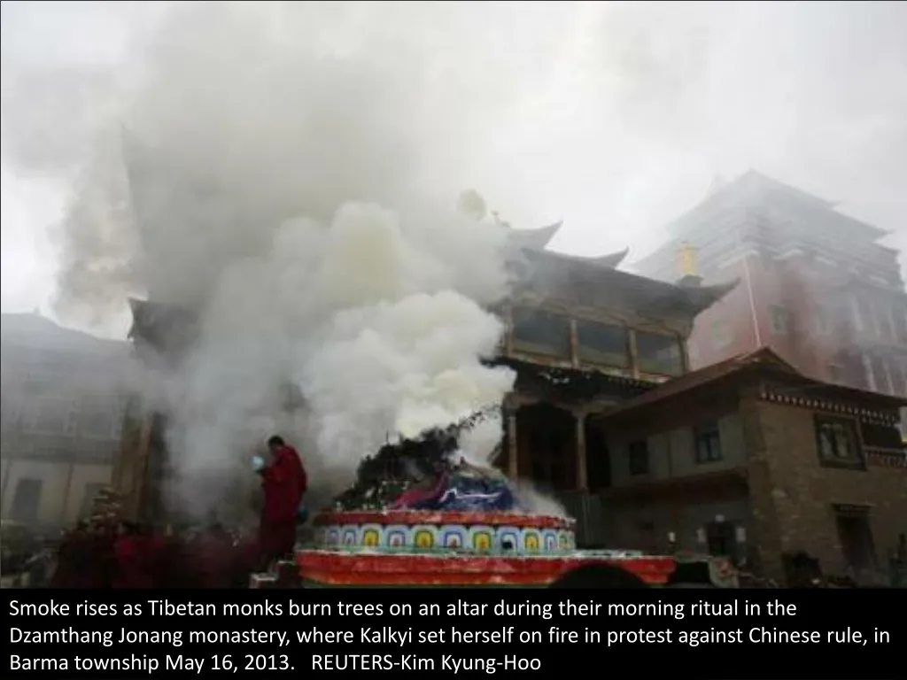 smoke rises as tibetan monks burn trees