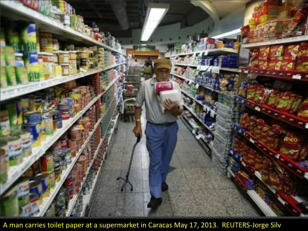 a man carries toilet paper at a supermarket