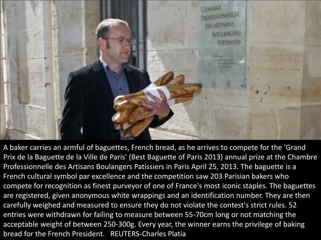 a baker carries an armful of baguettes french