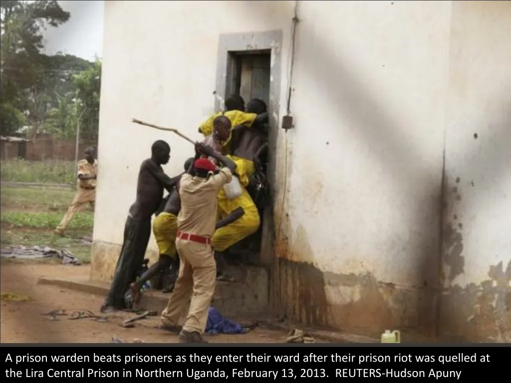 a prison warden beats prisoners as they enter
