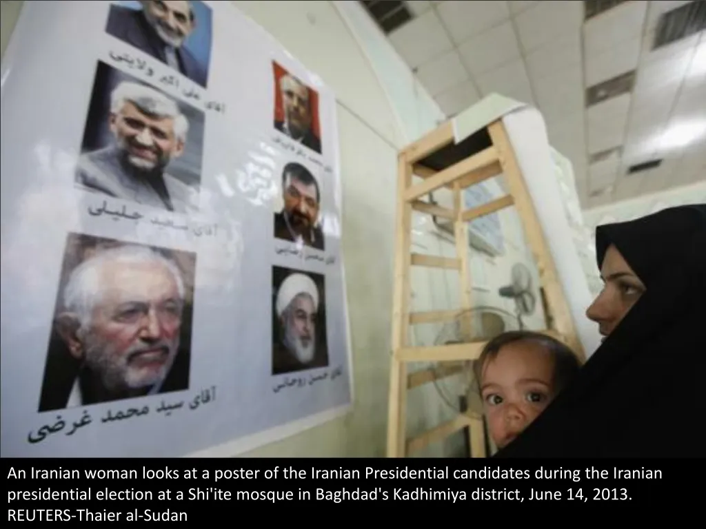 an iranian woman looks at a poster of the iranian