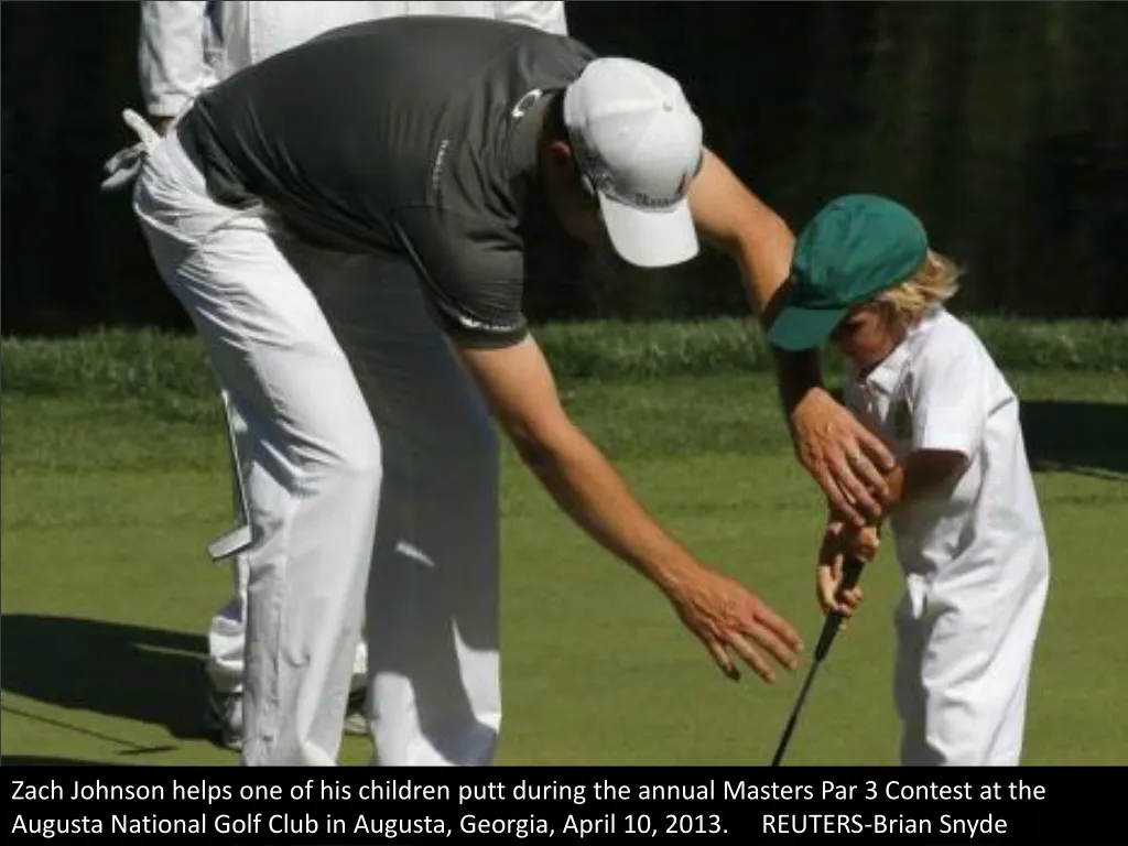 zach johnson helps one of his children putt