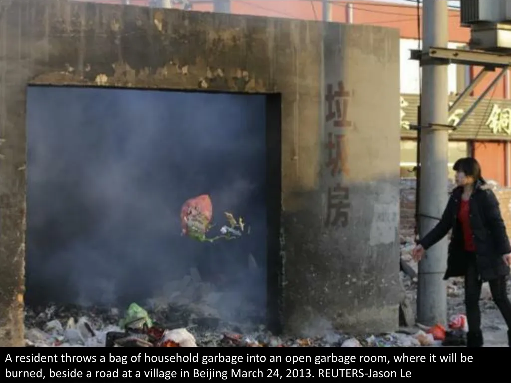 a resident throws a bag of household garbage into