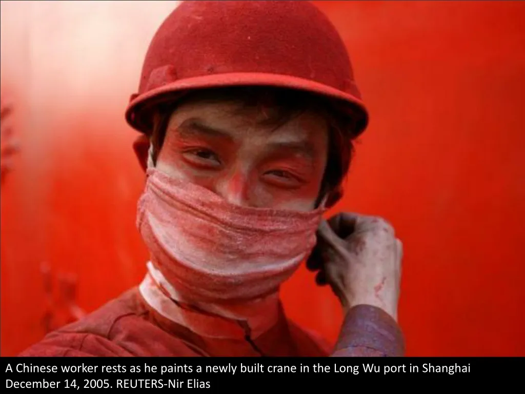 a chinese worker rests as he paints a newly built