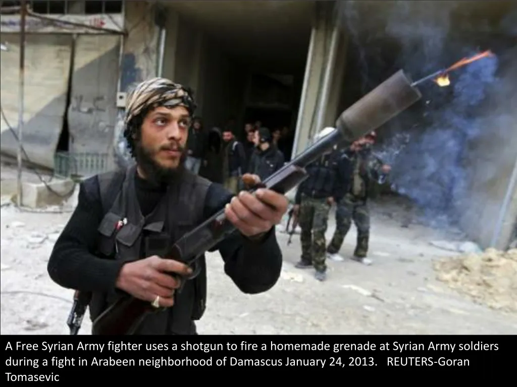a free syrian army fighter uses a shotgun to fire