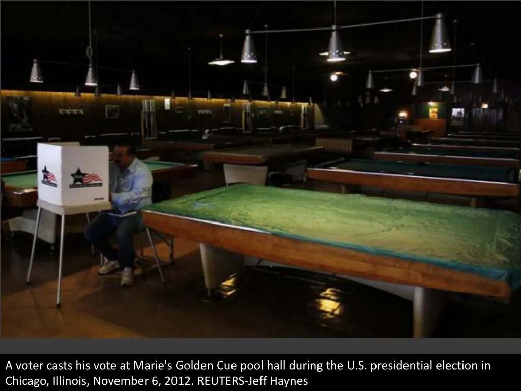 a voter casts his vote at marie s golden cue pool