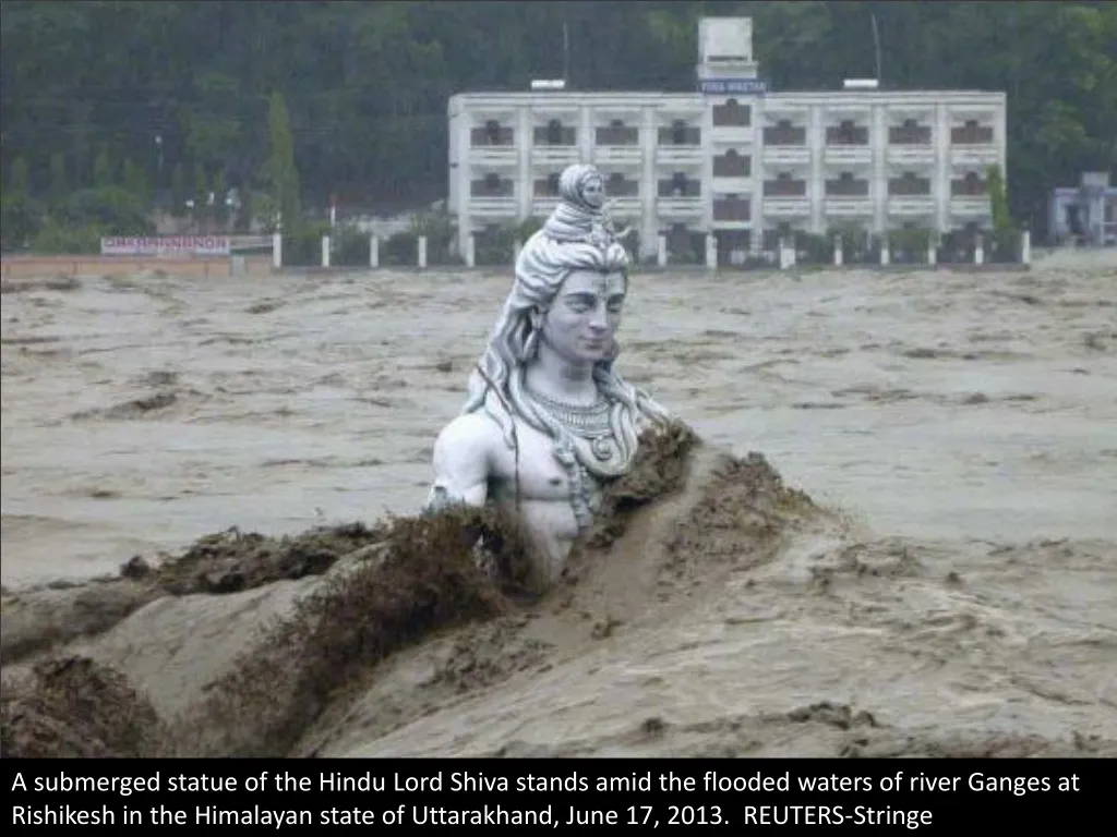 a submerged statue of the hindu lord shiva stands