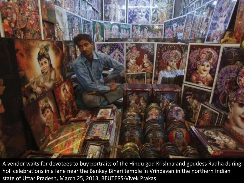 a vendor waits for devotees to buy portraits