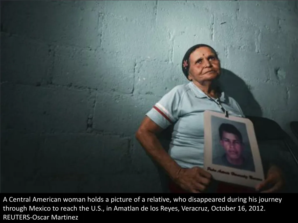 a central american woman holds a picture