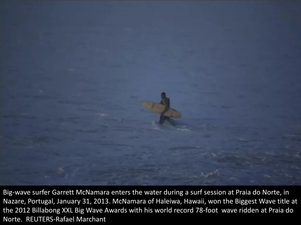 big wave surfer garrett mcnamara enters the water