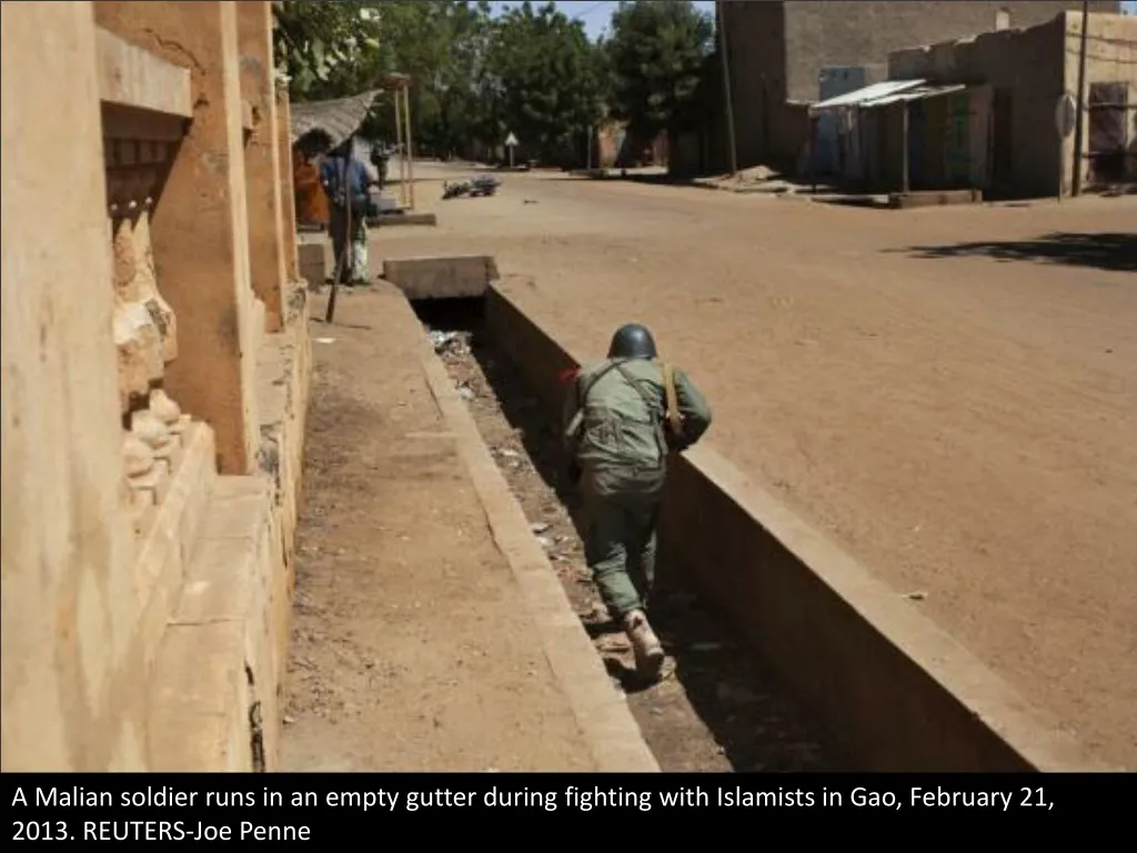 a malian soldier runs in an empty gutter during