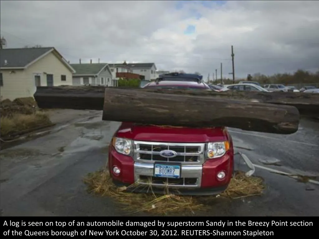 a log is seen on top of an automobile damaged