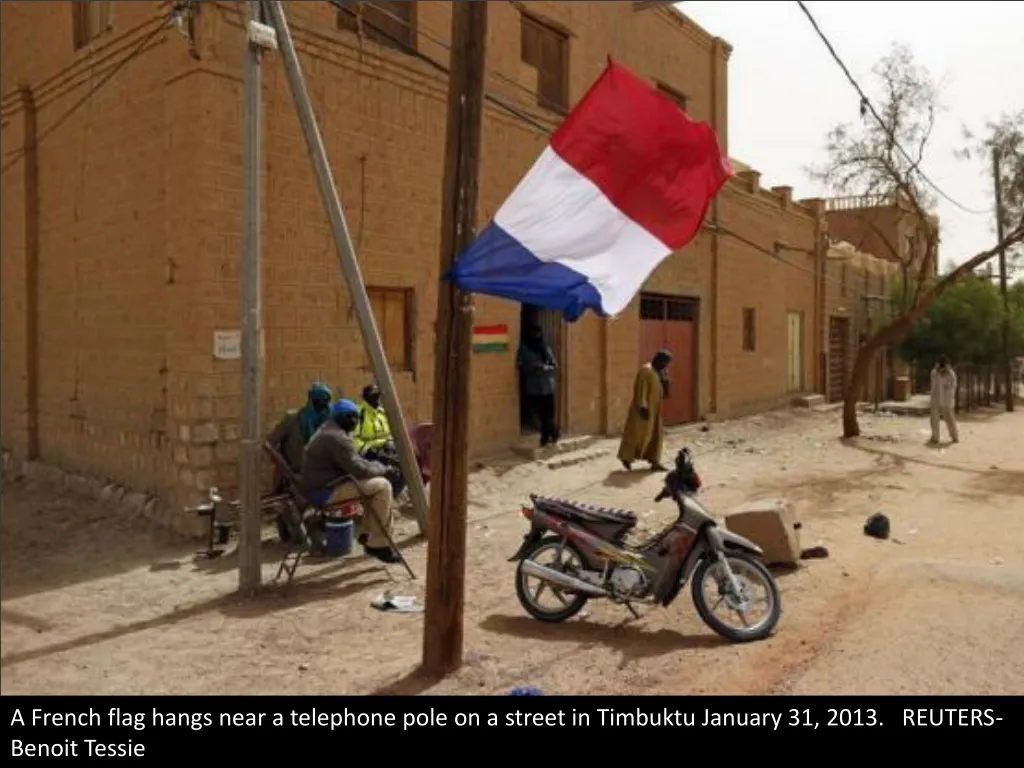 a french flag hangs near a telephone pole