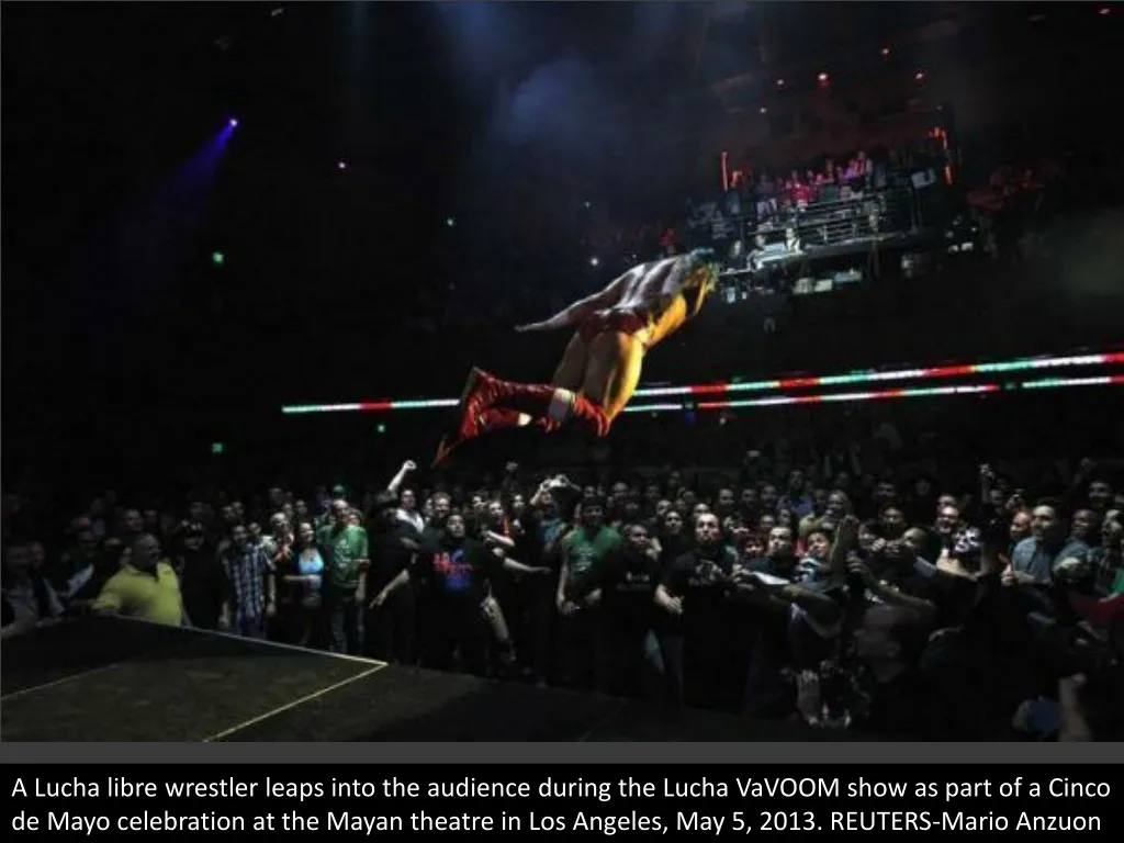 a lucha libre wrestler leaps into the audience