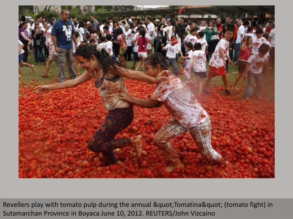 revellers play with tomato pulp during the annual